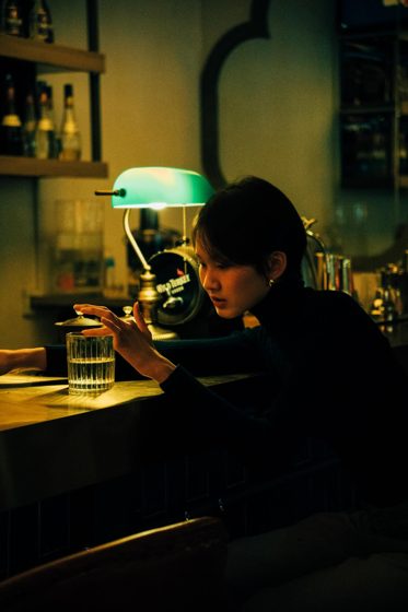 Thảo, Night bar, black turtleneck, frame 2 of 6